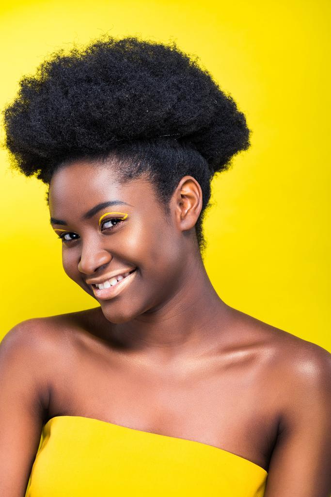 Χαρούμενος χαμογελαστός Αφρικανός Αμερικανός κορίτσι με μακιγιάζ απομονώνεται σε κίτρινο - Φωτογραφία, εικόνα