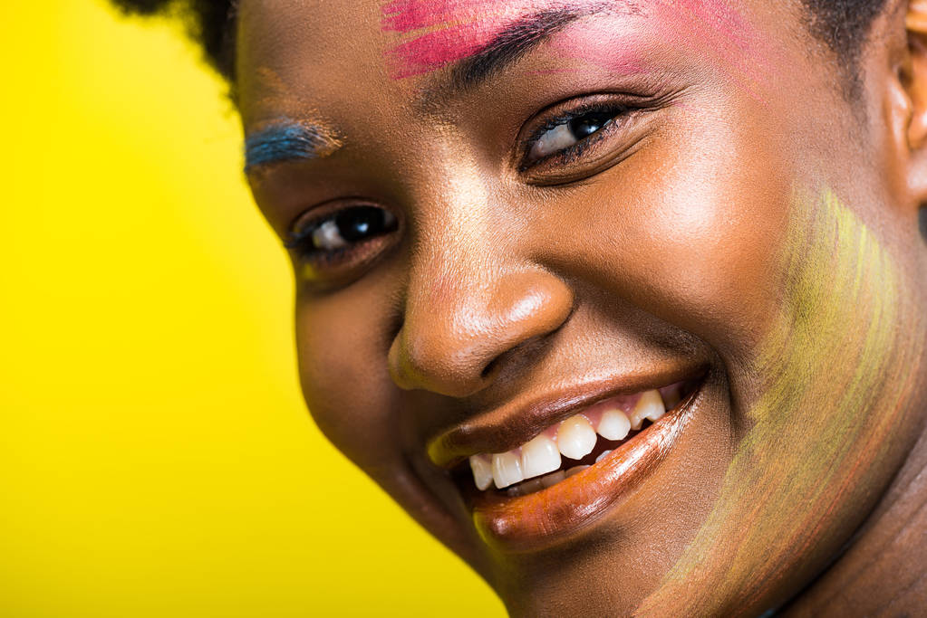 Przycięte widok uśmiechniętej African American kobieta z ciała sztuki na żółto - Zdjęcie, obraz