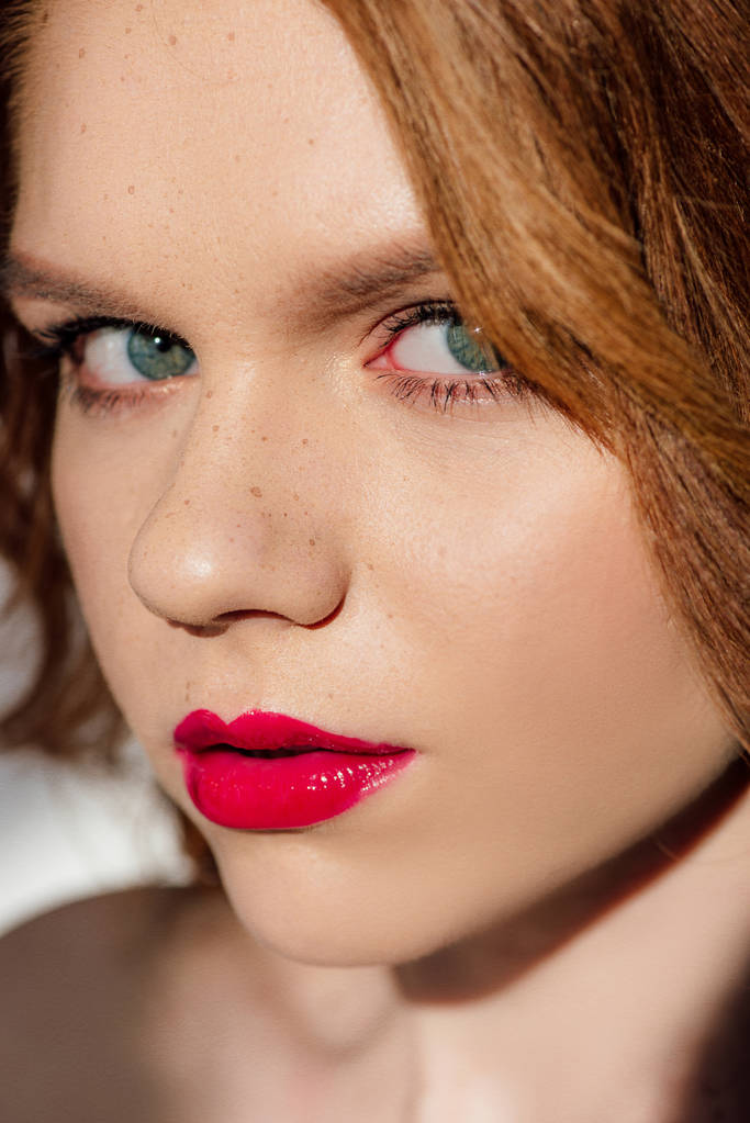 portrait of beautiful young redhead woman with red lips looking at camera - Photo, Image