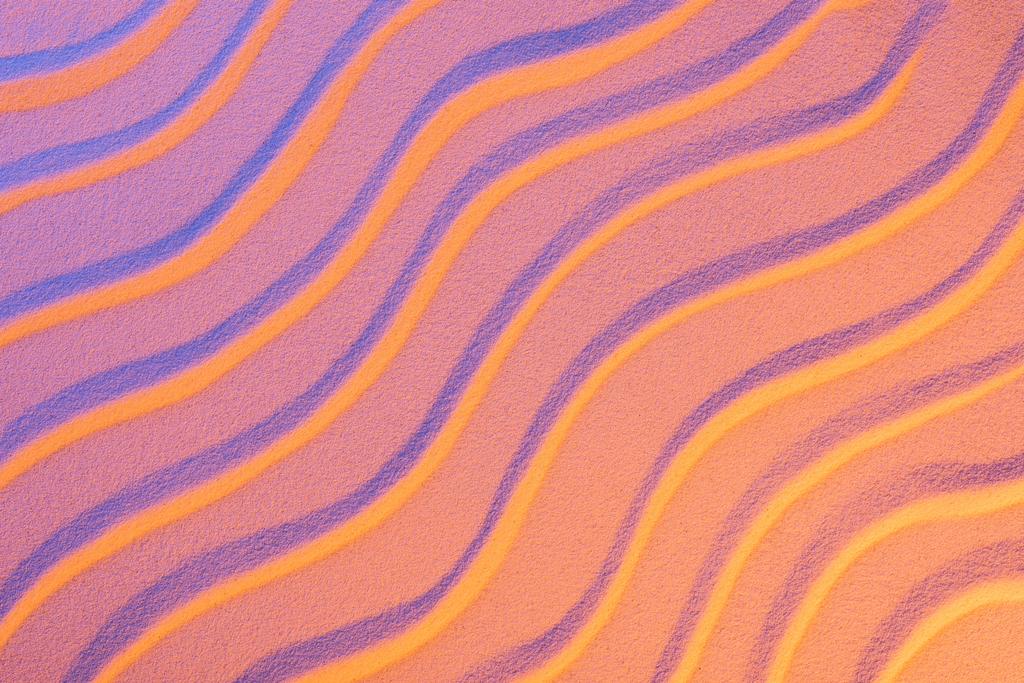 top view of textured sand with smooth waves and neon pink color filter - Photo, Image