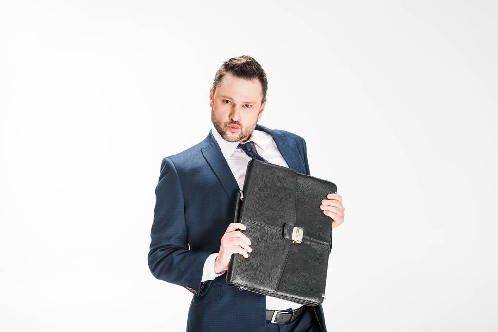 chubby businessman holding briefcase and looking at camera on white with copy space - Photo, Image