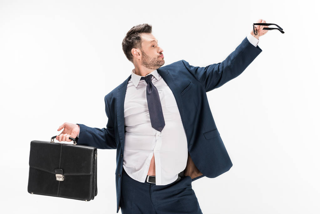overweight businessman in tight formal wear with briefcase and glasses isolated on white - Photo, Image