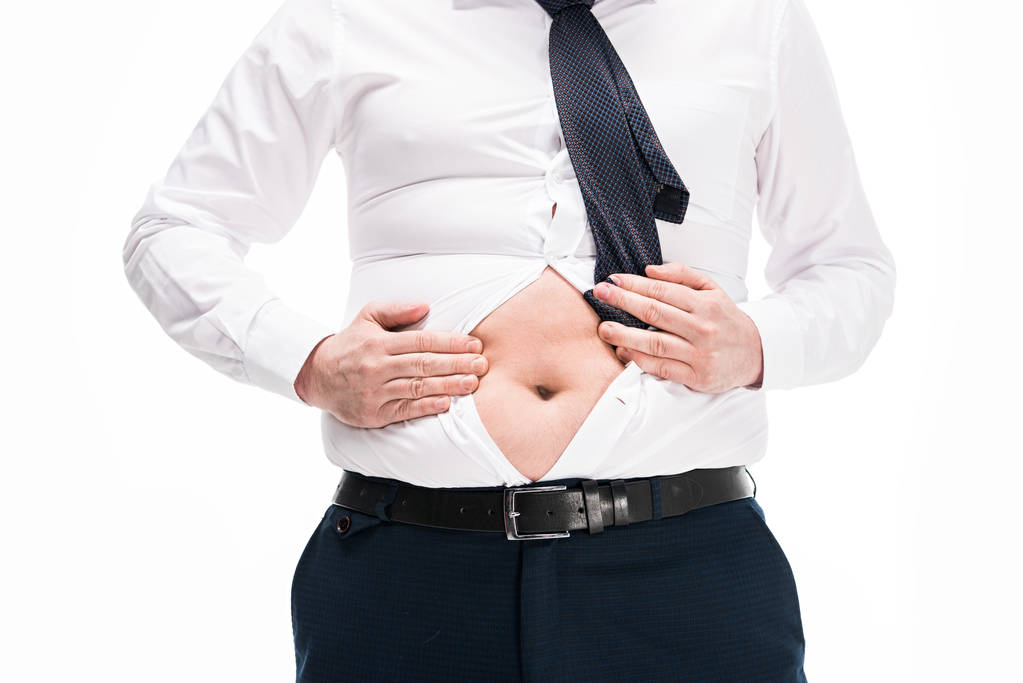 vista parcial del hombre con sobrepeso en apretado desgaste formal que muestra el vientre aislado en blanco
 - Foto, imagen