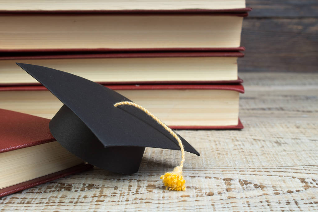 education concept. Graduation hat with gold tassel on the books. Law concep- with copy space for your ad text - Photo, Image