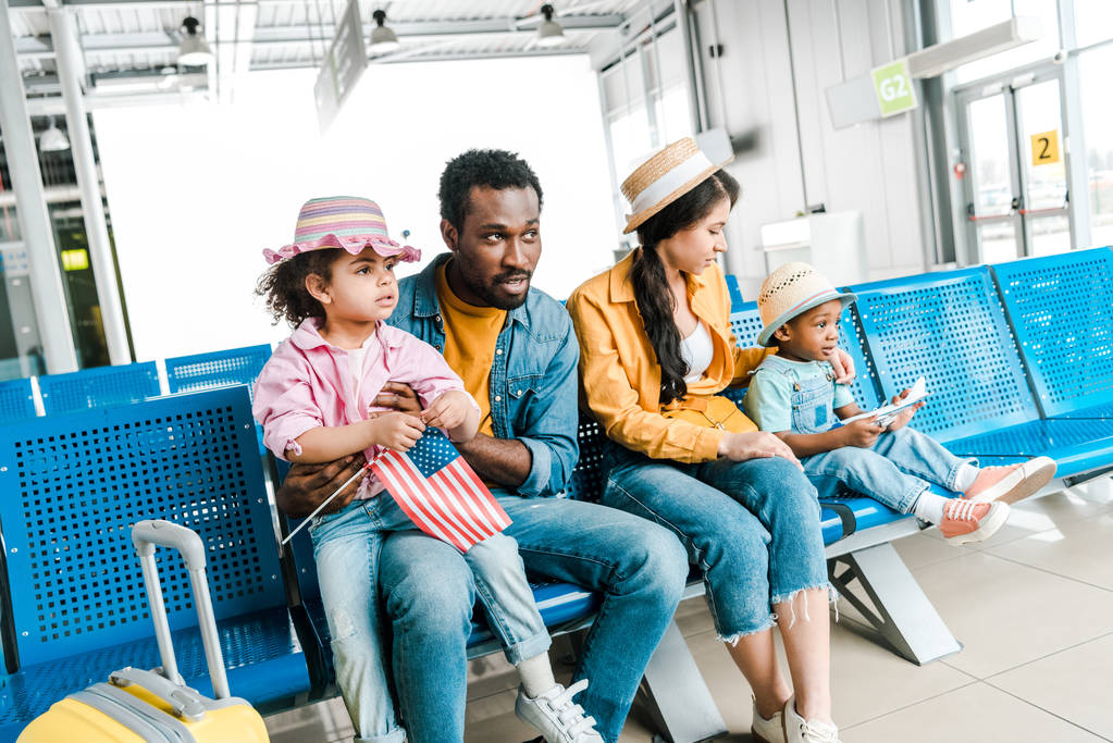 african american family sitting in departure lounge in airport with baggage - Photo, Image