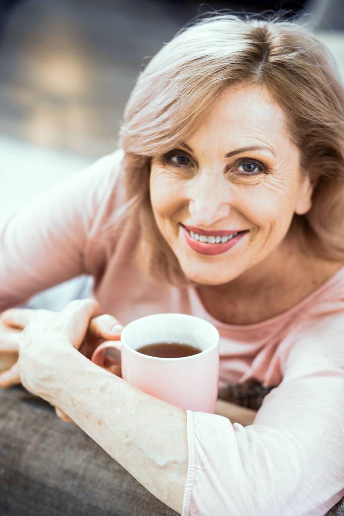 Una mujer de más de 50 años de apariencia europea descansando en casa bebiendo té
. - Foto, imagen