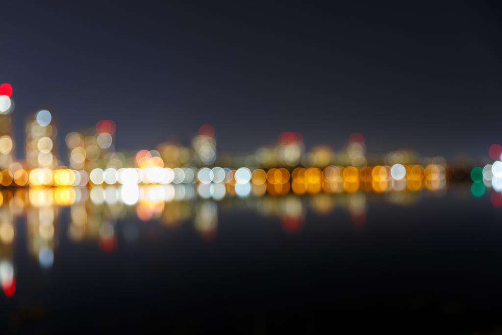 Işıklı binalar ve yansıma ile karanlık Cityscape bulanık - Fotoğraf, Görsel
