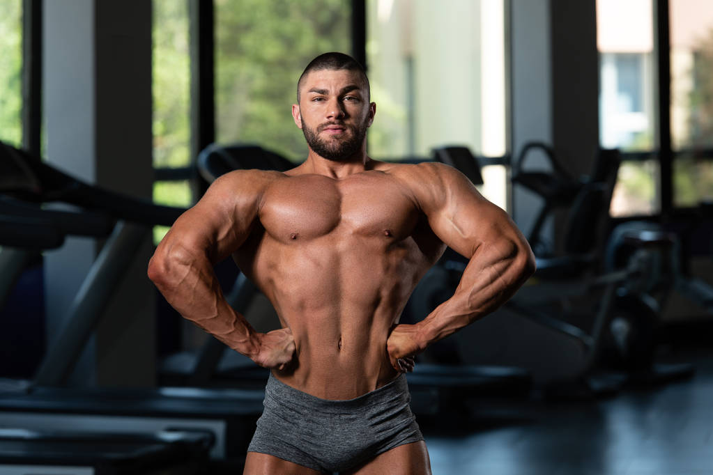 Handsome Muscular Man Flexing Muscles In Gym - Photo, Image