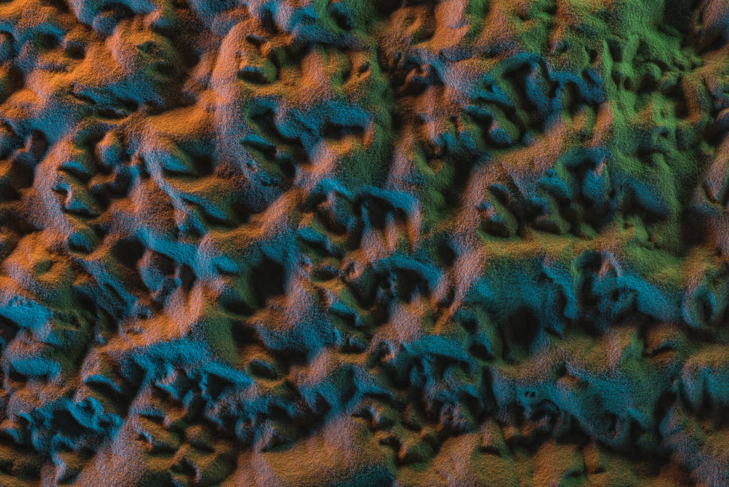 vue de dessus du sable texturé avec des lumières orange, vertes et bleues
 - Photo, image