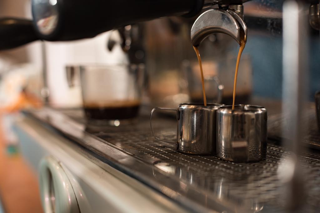 Selective focus of coffee machine and two stainless cups - Photo, Image