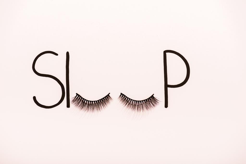 top view of word sleep made with fake eyelashes isolated on beige - Photo, Image