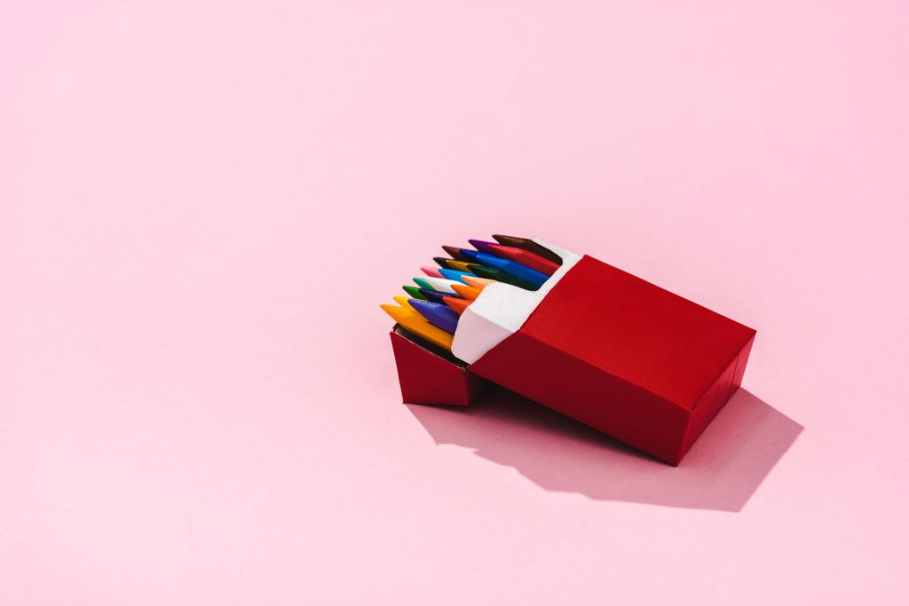 Kolorowe kredki w opakowaniu papierosów na różowym z kopią przestrzeni, koncepcja palenia  - Zdjęcie, obraz