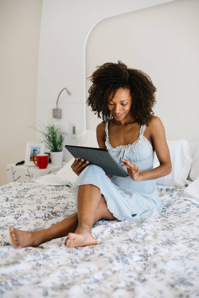 Mujer en casa leyendo en tableta digital
 - Foto, Imagen