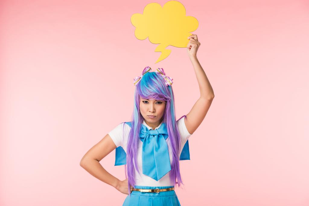 Dissatisfied asian anime girl holding thought bubble on pink - Photo, Image
