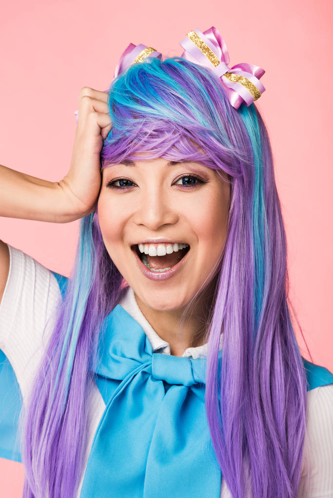 riéndose asiático anime chica en púrpura peluca mirando cámara en rosa
 - Foto, Imagen