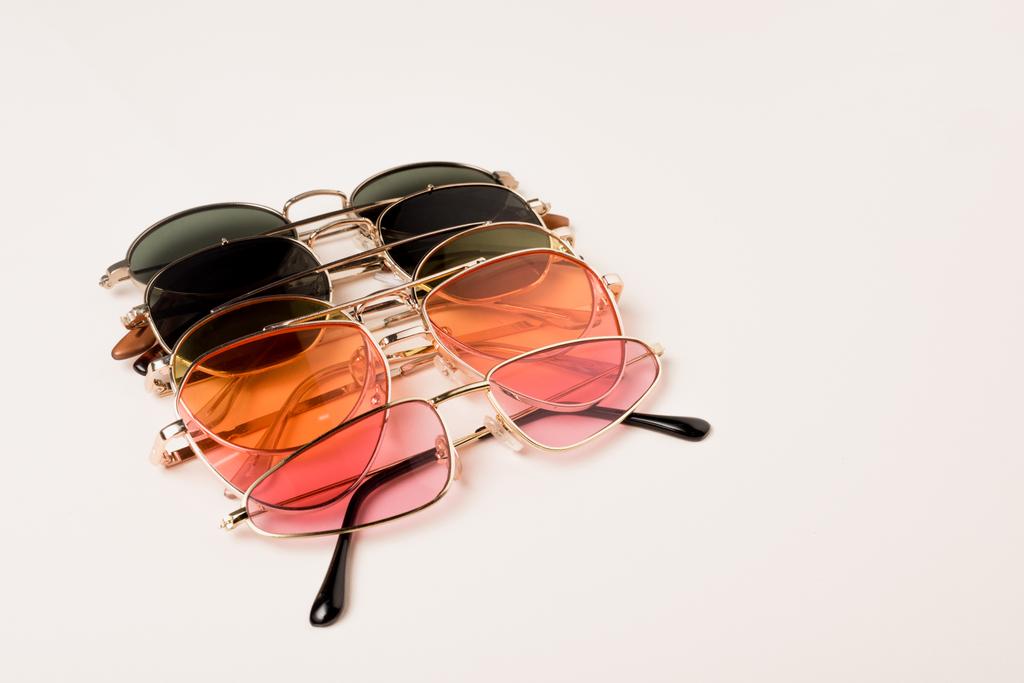 стильні барвисті сонцезахисні окуляри на білій поверхні з копіювальним простором
 - Фото, зображення