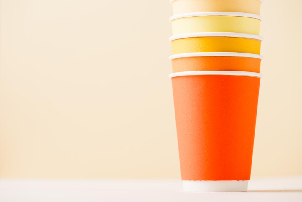 colorful disposable cups on white surface isolated on beige - Photo, Image
