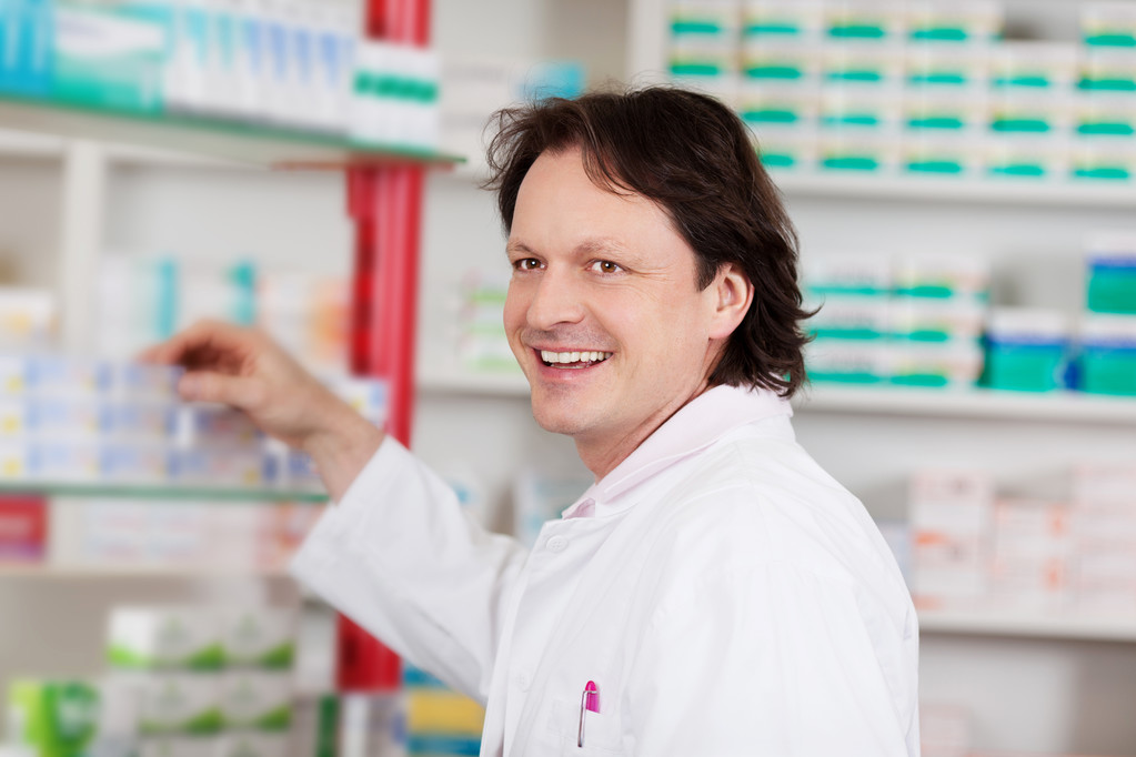 smiling pharmacist in front of shelf - Photo, Image