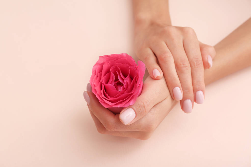 Closeup view of woman with rose on color background, space for text. Spa treatment - Photo, Image