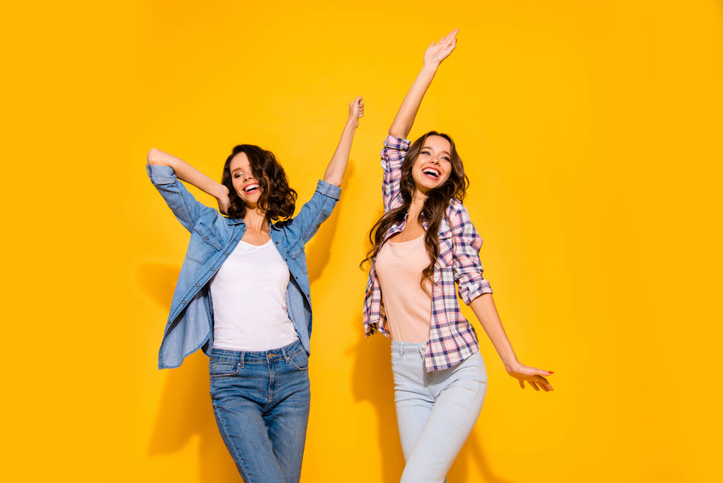 Portrait of cute lovely teen teenagers enjoy glad content spring free time weekends holidays raise hands arms dream dreamy candid dressed plaid modern outfit isolated on yellow background  - Photo, Image