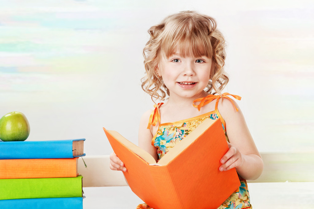 Beautiful girl with books, on a gray background - Photo, Image