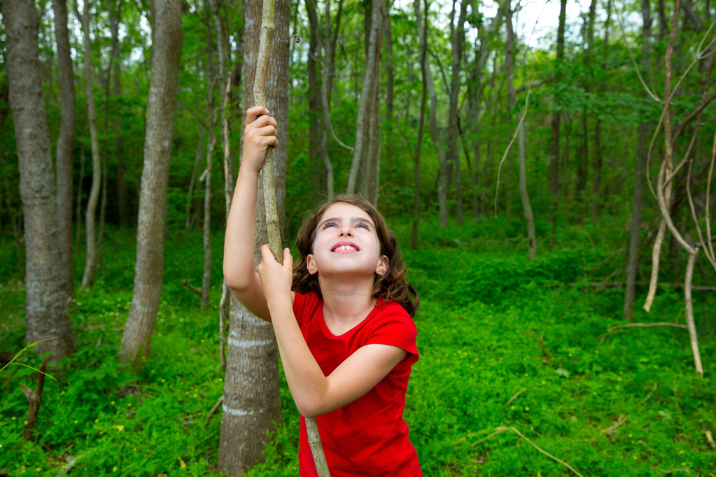 Chica feliz jugando en la selva parque forestal con liana
 - Foto, imagen