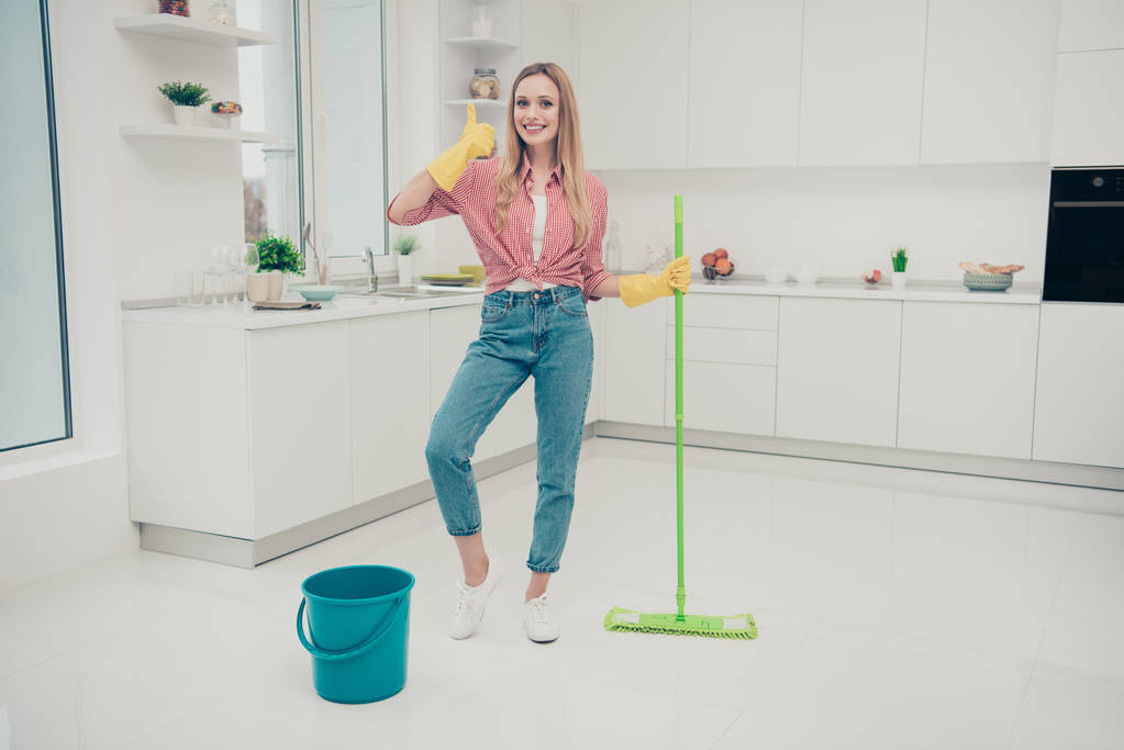 Full length body size photo beautiful nice domestic duties she her lady wash white shiny floor finished work thumb up nice result wear jeans casual checkered plaid shirt bright light kitchen
 - Фото, изображение
