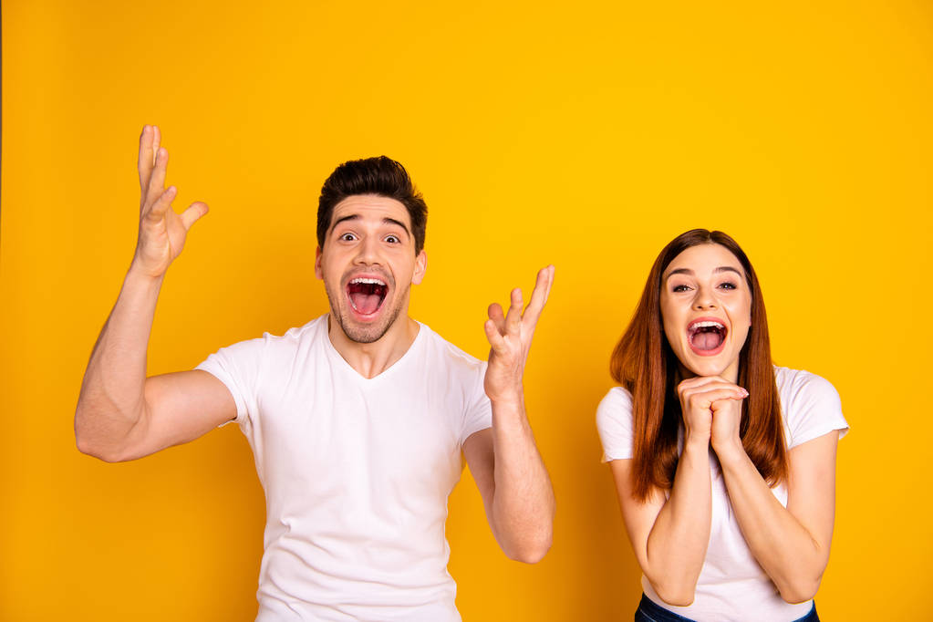 Close up photo amazing she her he him his couple hands arms hold air yell unbelievable brilliant luck lucky day cheerleader football match wear casual white t-shirts outfit isolated yellow background - Photo, Image