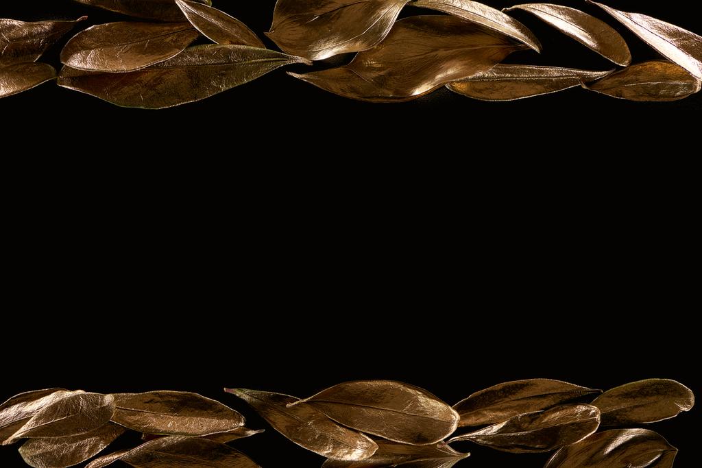 top view of golden metal decorative leaves isolated on black - Photo, Image