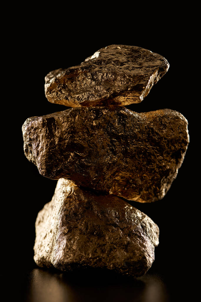 close up of gold textured shiny stones in pile isolated on black - Photo, Image