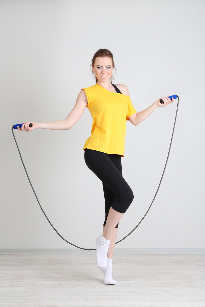 Beautiful young woman with skipping rope - Photo, Image