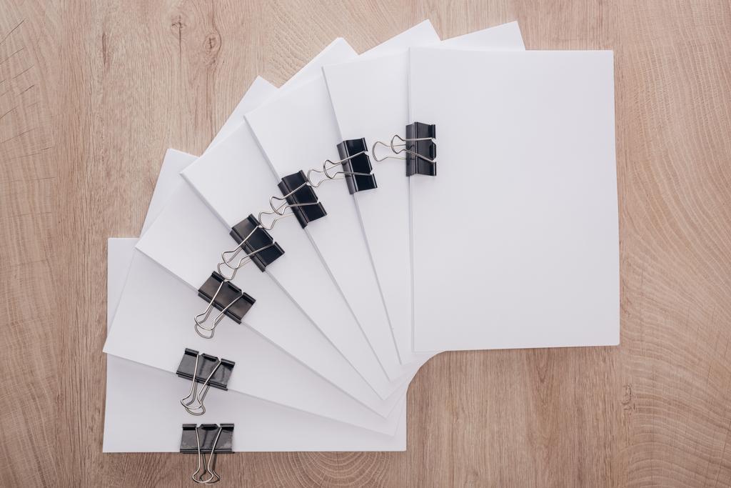 top view of stacks of blank paper with metal paper clips and copy space on table - Photo, Image