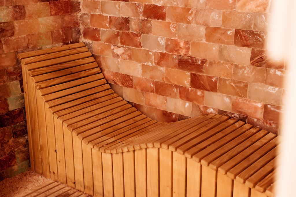 banco de madera en el centro de spa con paredes texturizadas
 - Foto, Imagen