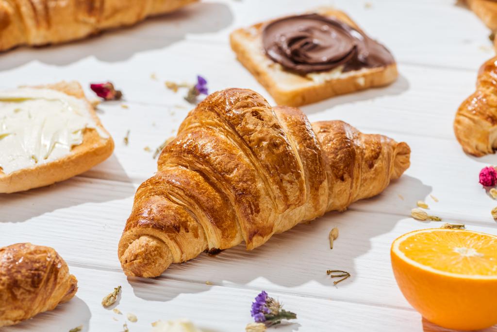 selective focus of croissant near toast with chocolate cream on white  - Photo, Image