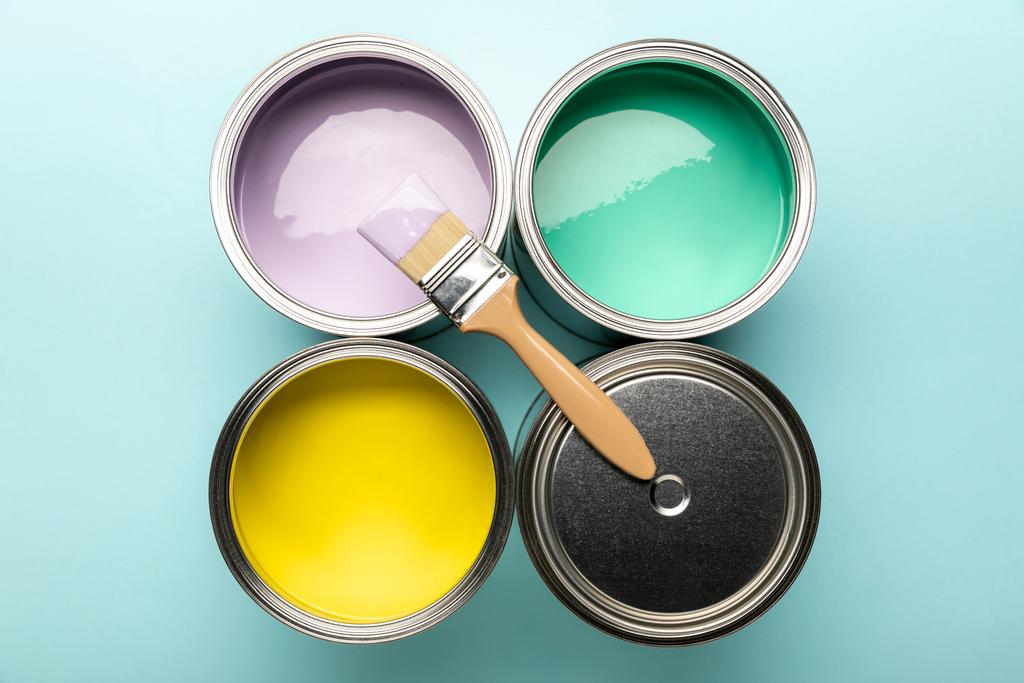 top view of tins of paints and brush on blue surface - Photo, Image