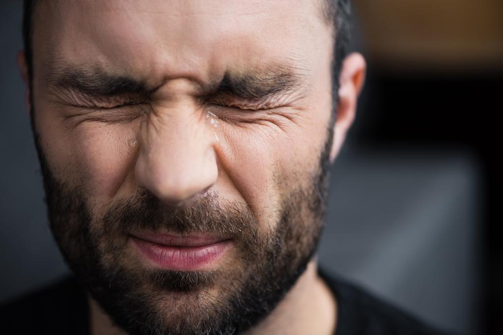 portrait of depressed bearded man crying with closed eyes - Photo, Image