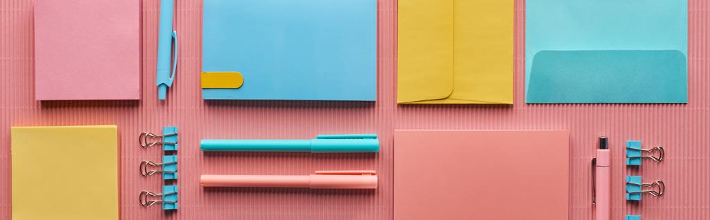 panoramic shot of various colorful stationery supplies on pink  - Photo, Image