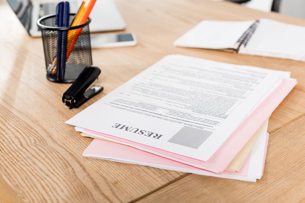 selective focus of resume near stapler and pen holder on table  - Photo, Image