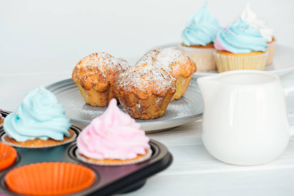 lahodné muffiny a dortíky s barevným nápětím izolované na šedé - Fotografie, Obrázek