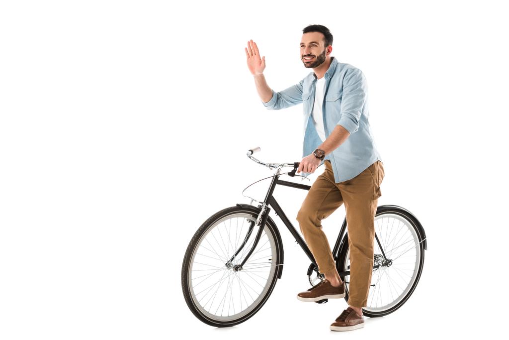 веселый человек с велосипедом показывает привет жест и глядя в сторону изолированы на белом
 - Фото, изображение