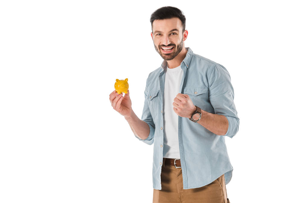 happy handsome man holding piggy bank and showing yes gesture isolated on white - Photo, Image