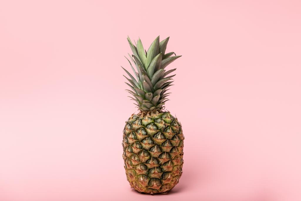 fresh tasty and raw pineapple with green leaves on pink  - Photo, Image