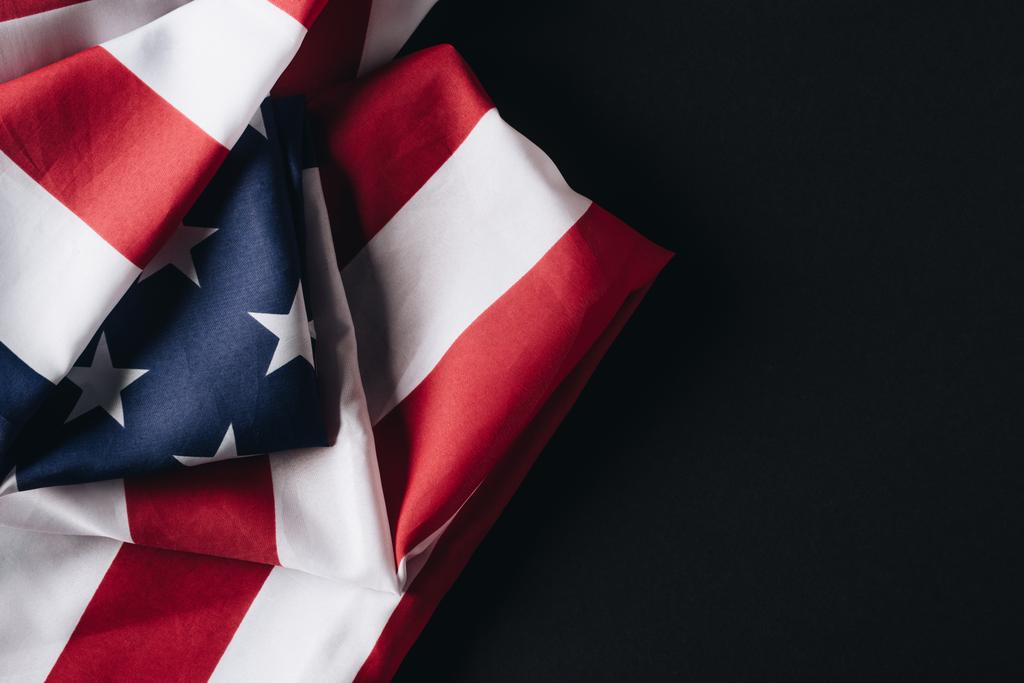 folded united states of america national flag isolated on black, memorial day concept - Photo, Image