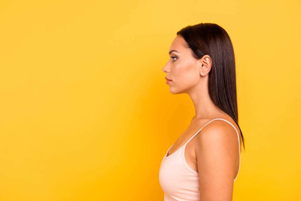 Close up side profile photo beautiful she her lady look empty space not smiling zombie facial expression no emotions stare wear casual pastel tank-top outfit clothes isolated yellow bright background - Photo, Image