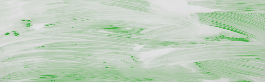 panoramic shot of glass covered with foam on green background - Photo, Image