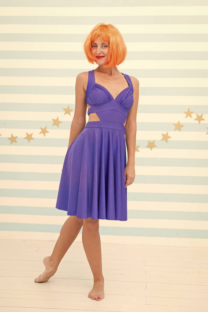 Woman playful mood having fun. Fun and entertainment. Girl bob wig posing striped background of studio. Create your own mood. Lady red or ginger wig posing in blue dress. Comic and humorous concept - Photo, Image