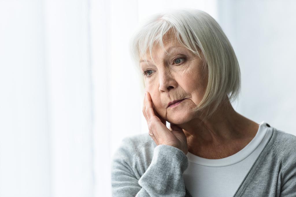 pensive senior woman with grey hair looking away at home - Photo, Image