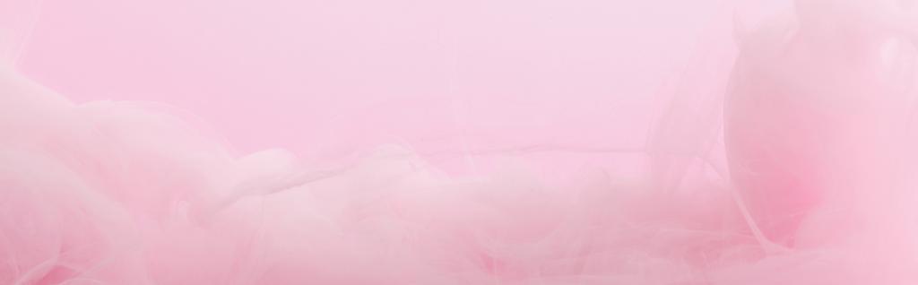 Close up view of pink paint swirls mixing isolated on pink - Photo, Image