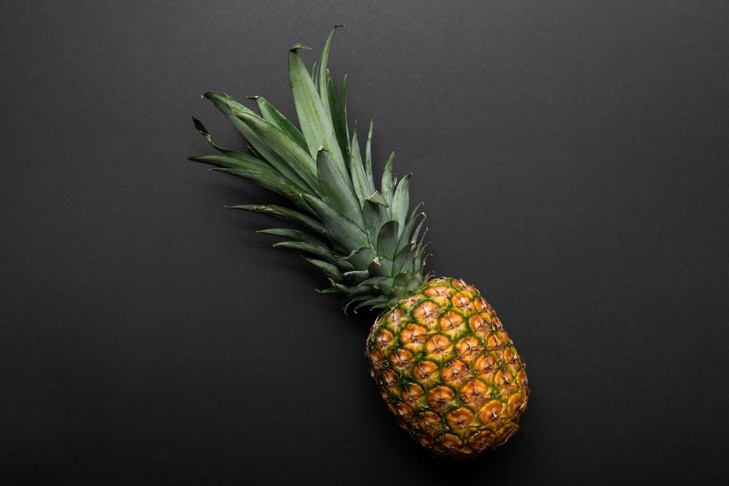 top view of ripe yellow pineapple on black background - Photo, Image
