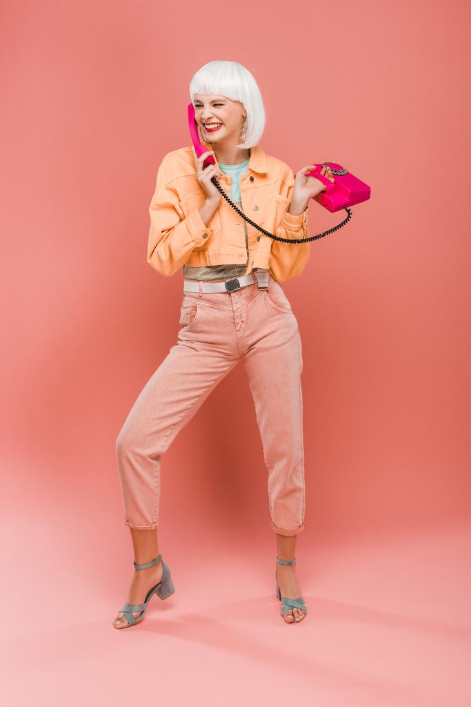 menina da moda feliz em peruca branca falando no telefone vintage em rosa
  - Foto, Imagem